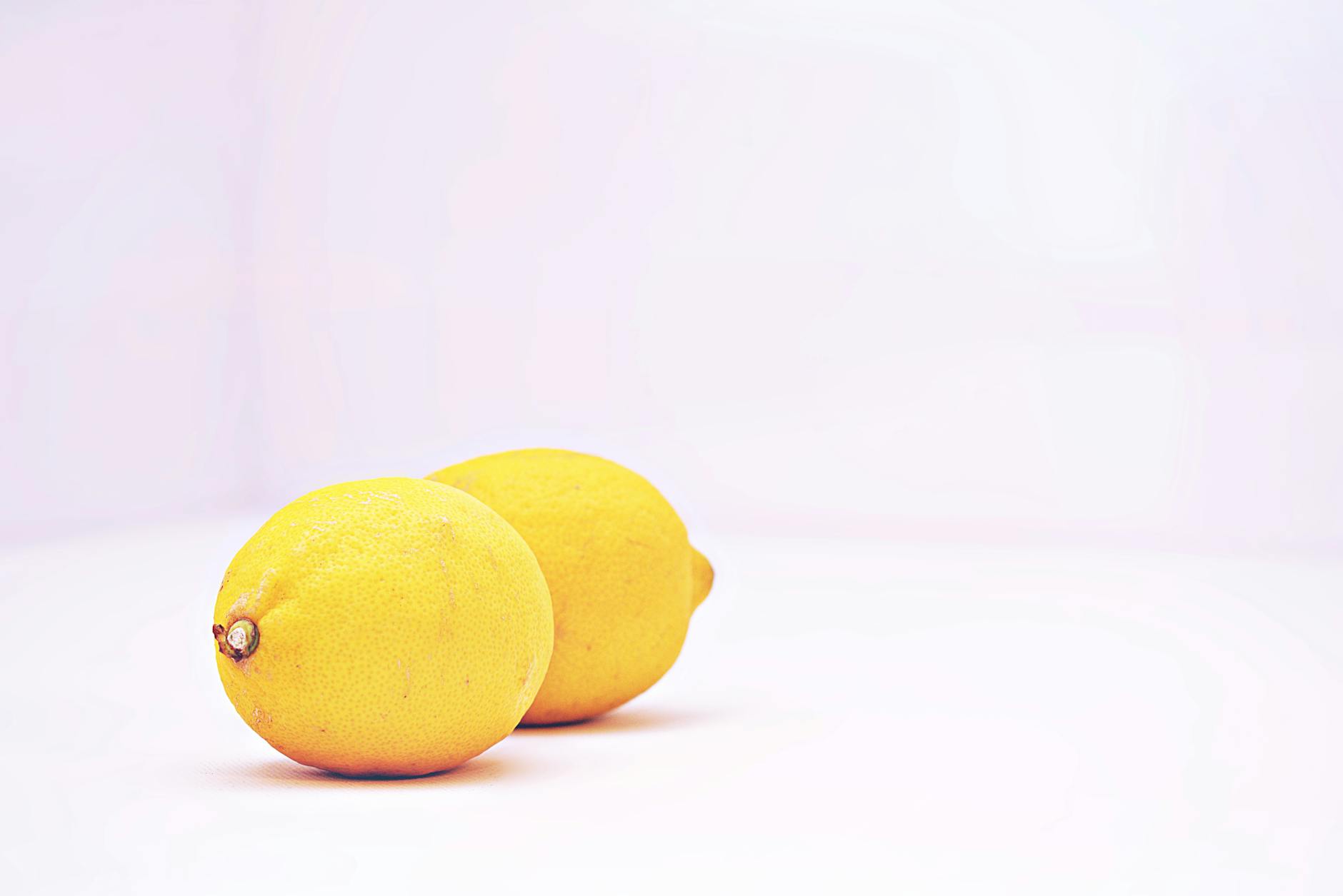 A vibrant arrangement of colorful clitoral vibrators displayed on a bright yellow surface