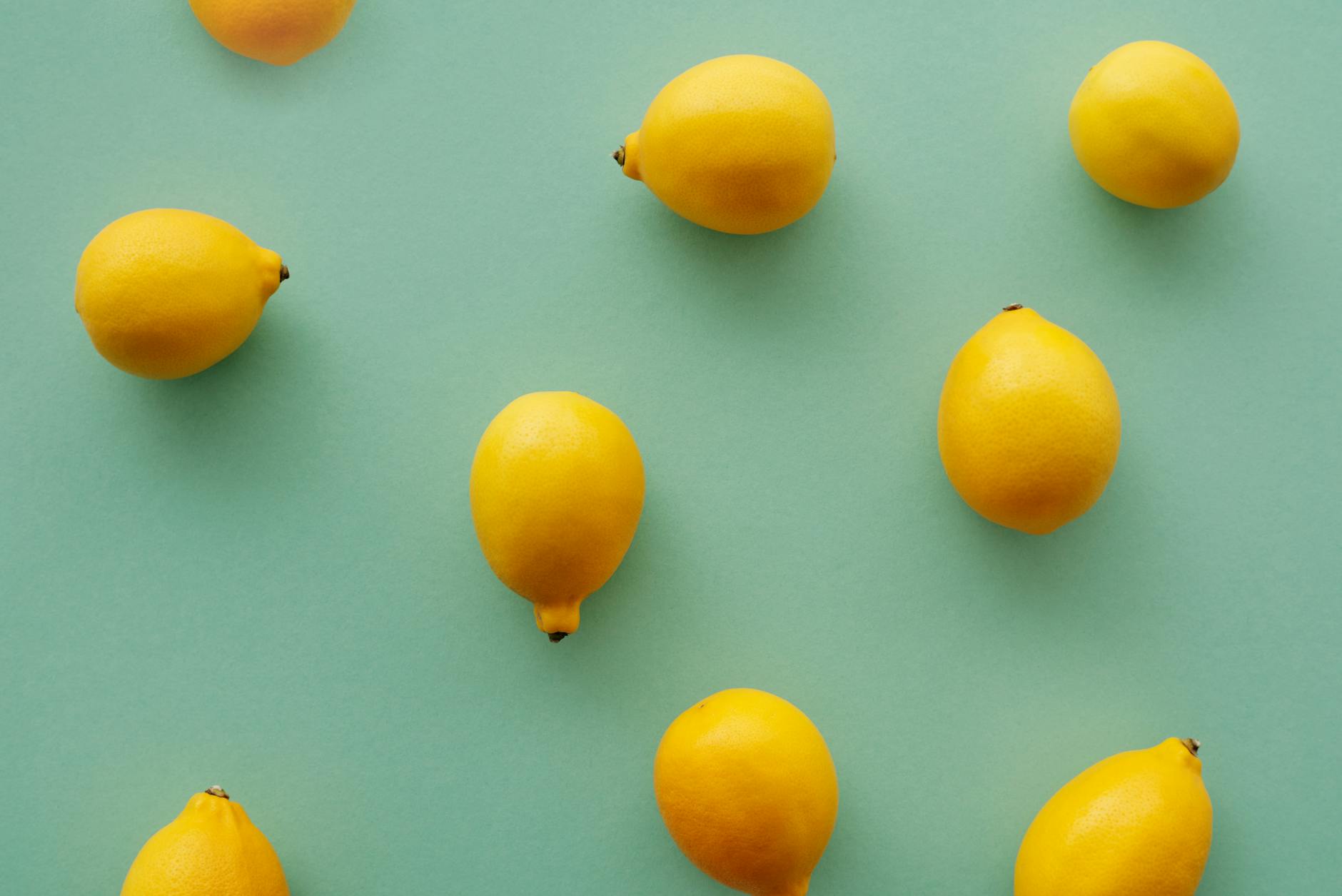 Bright yellow lemons on a soft green background, symbolizing gentle renewal and recovery