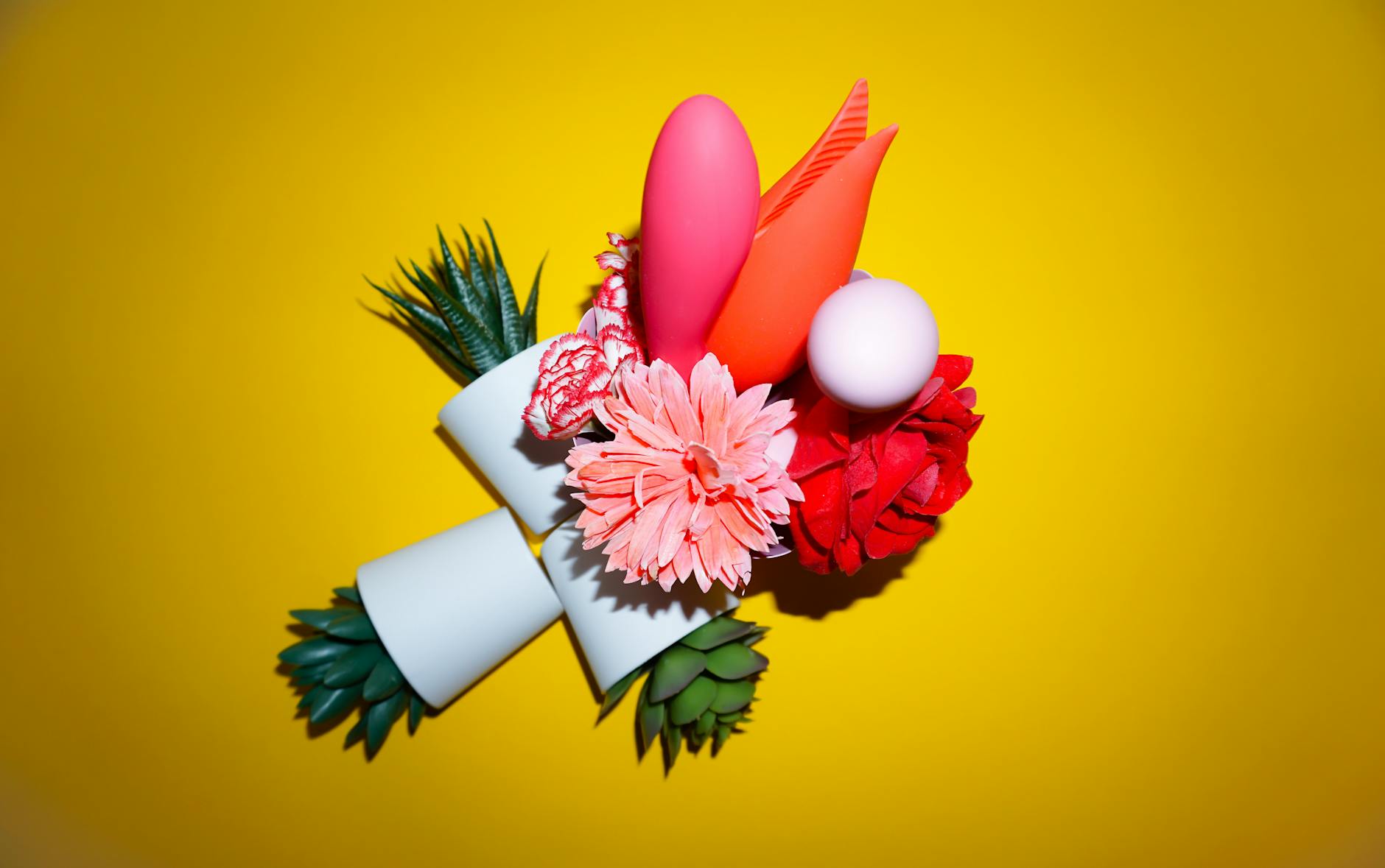 Hand holding a fresh lemon against a bright yellow background, representing the fresh and intuitive design of lemon vibrators